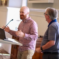 Josh and Greg presenting to audience